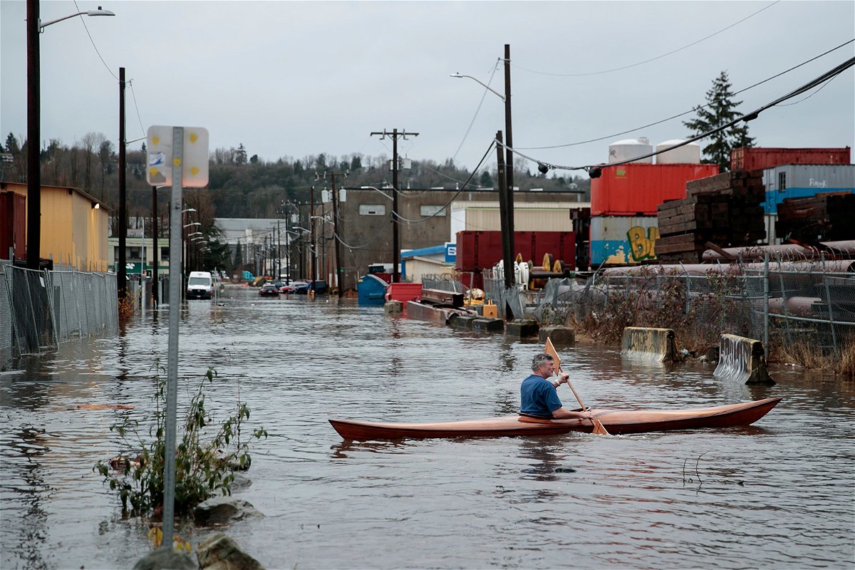 A person kayaks through Seattle's South Park neighborhood on Tuesday