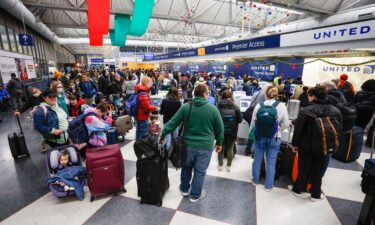 The massive winter storm battering the US with plunging temperatures coast-to-coast has left thousands without power. Travelers wait in line to check-in for their flights ahead of the Christmas Holiday at O'Hare International Airport on December 22