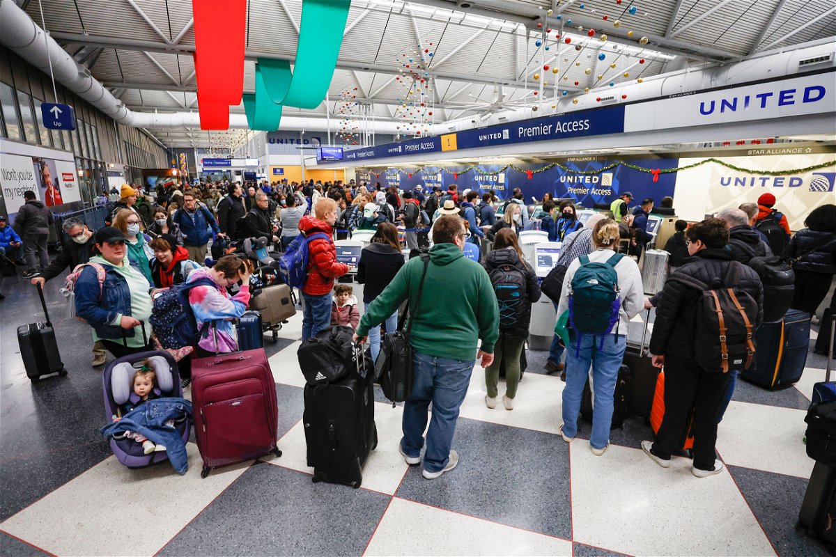 The massive winter storm battering the US with plunging temperatures coast-to-coast has left thousands without power. Travelers wait in line to check-in for their flights ahead of the Christmas Holiday at O'Hare International Airport on December 22