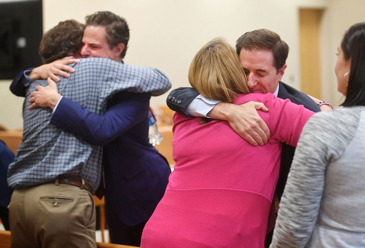 <i>Brian A. Poinds/Pool/Hearst Connecticut Media/Reuters</i><br/>Plaintiff William Sherlach hugs attorney Josh Koskoff while plaintiff Nicole Hockley hugs attorney Chris Mattei following the jury verdict and reading of monetary damages in the Alex Jones defamation trial in Waterbury