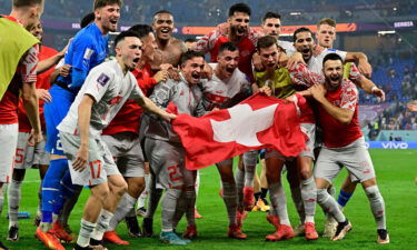 Switzerland celebrates defeating Serbia 3-2 and qualifying for the knockout stages.