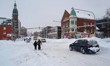 People and vehicles move about Main St. in Buffalo