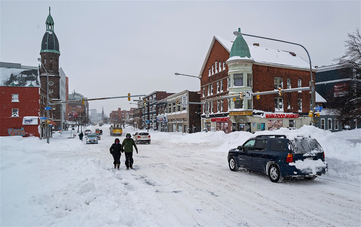 <i>Craig Ruttle/AP</i><br/>People and vehicles move about Main St. in Buffalo