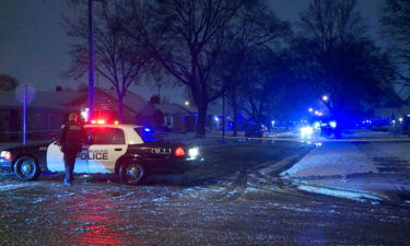 Police secure the scene where a mail carrier was shot to death Friday evening in Milwaukee.