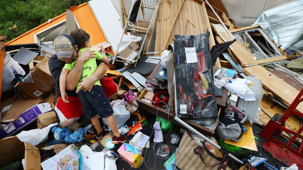 <i>Curtis Compton/Atlanta Journal-Constitution via AP</i><br/>Father and son survived a deadly tornado on April 13