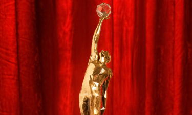 The bronze trophy features a player reaching for a crystal basketball.