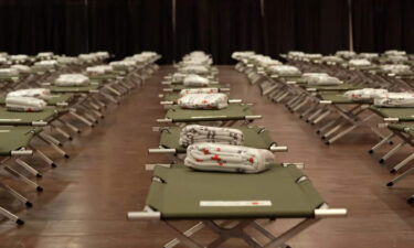 Beds are prepared for migrants at the El Paso Convention Center.