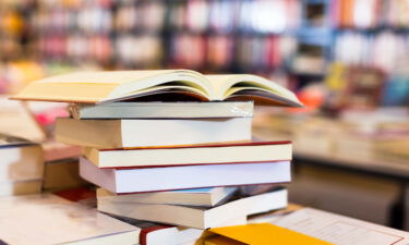 A stack of art books lying on a table in a bookstore is pictured here in this stock image.