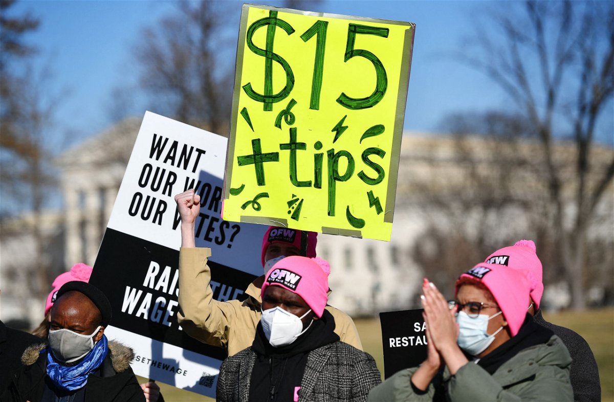 <i>Mandel Ngan/AFP/Getty Images</i><br/>An activist holds a placard demanding a $15 an hour minimum wage and tips for restaurant workers during a rally at the US Capitol on February 8