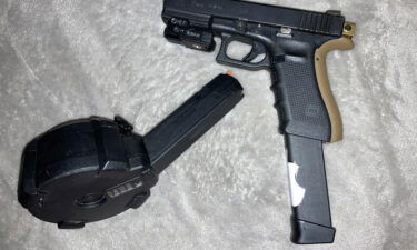 Albuquerque police released a photo of a "tan and black Glock with a drum magazine" that the affidavit said matches one of the guns seized from the suspect during a traffic stop.