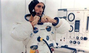Walt Cunningham adjusts his pressure suit before the Apollo 7 launch on October 11