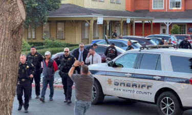 Police officers detain a man