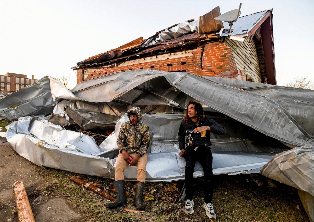 <i>Mickey Welsh/USA Today/Reuters</i><br/>Cordel Tyus and Devo McGraw sit on roofing that blew off of an industrial building and wrapped around their house Thursday after a tornado ripped through Selma
