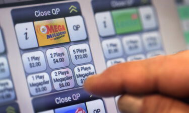 A customer purchases a Mega Millions lottery ticket at a 7-Eleven store on January 22