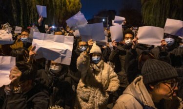 People hold up blank pieces of paper during a protest against China's zero-Covid measures on November 27