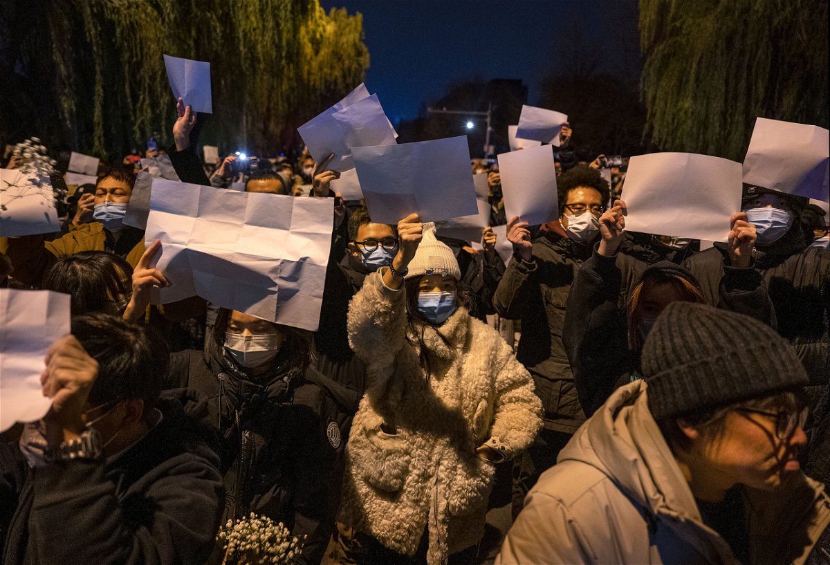 People hold up blank pieces of paper during a protest against China's zero-Covid measures on November 27