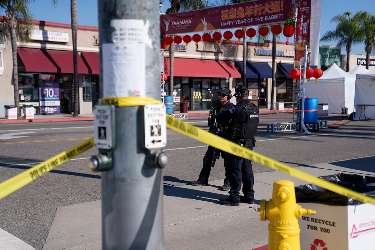 <i>Eric Thayer/Getty Images</i><br/>Police officers stand guard near the scene of a deadly shooting on January 22