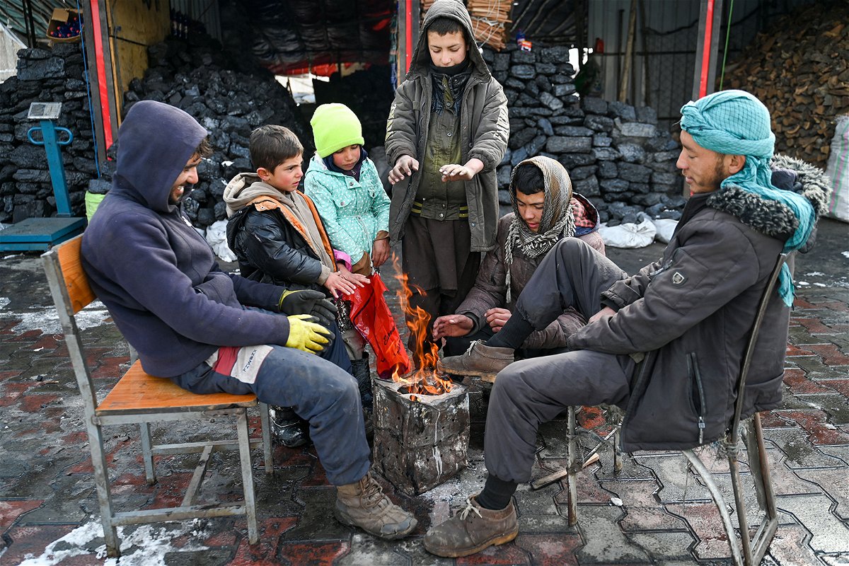 Afghans gather around a bonfire after snowfall in Kabul on January 23.