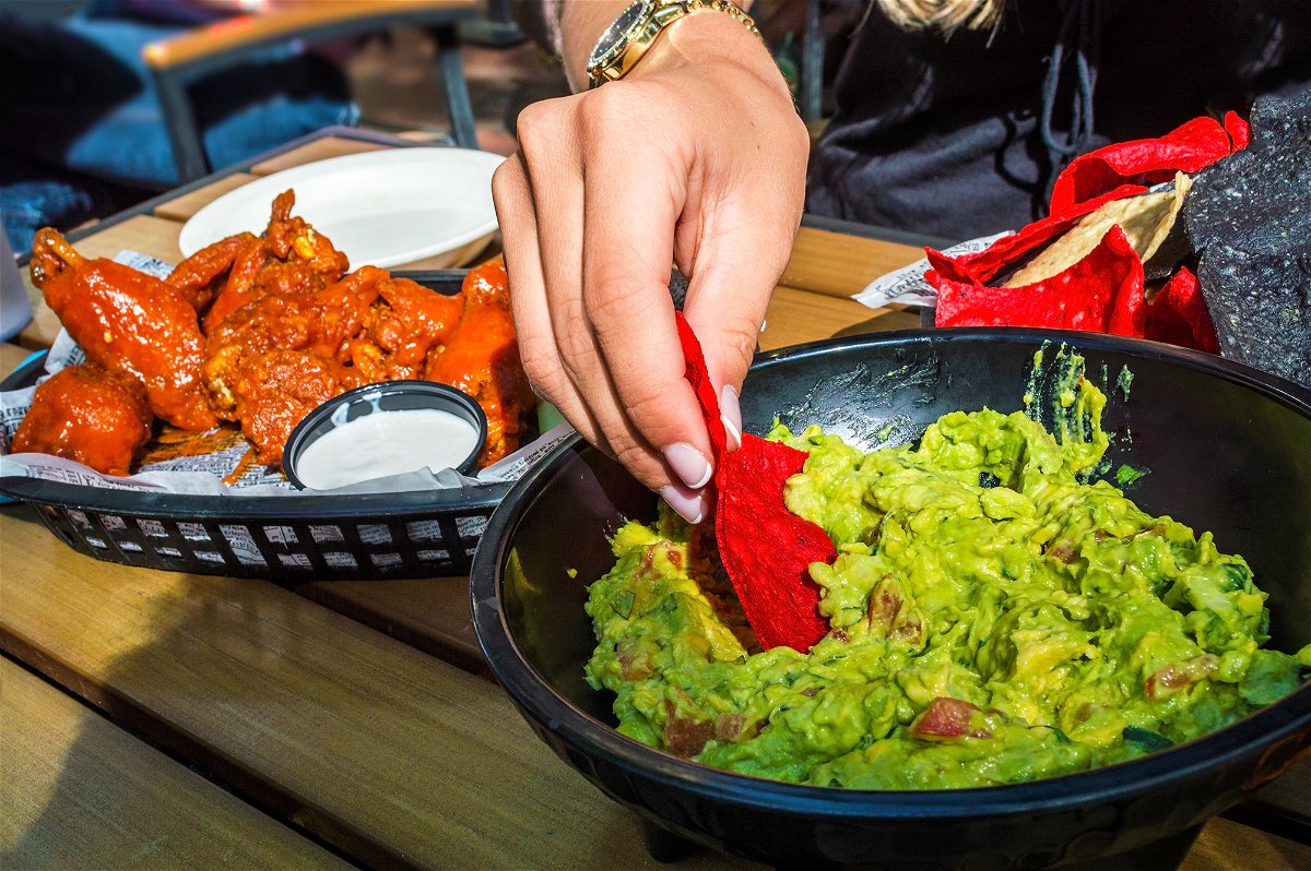 Chicken wings and guacamole will cost less this year.