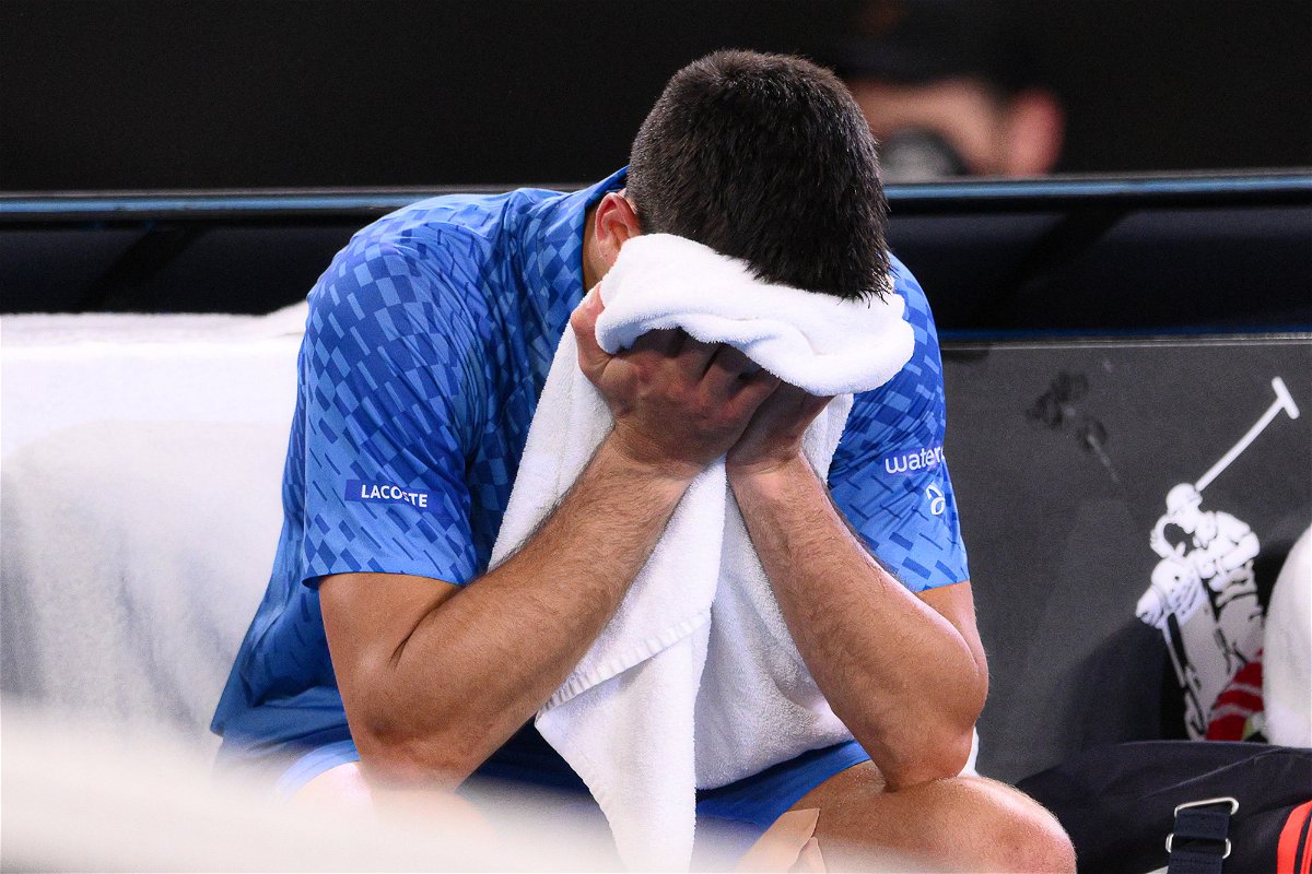 Djokovic cries into his towel after victory.