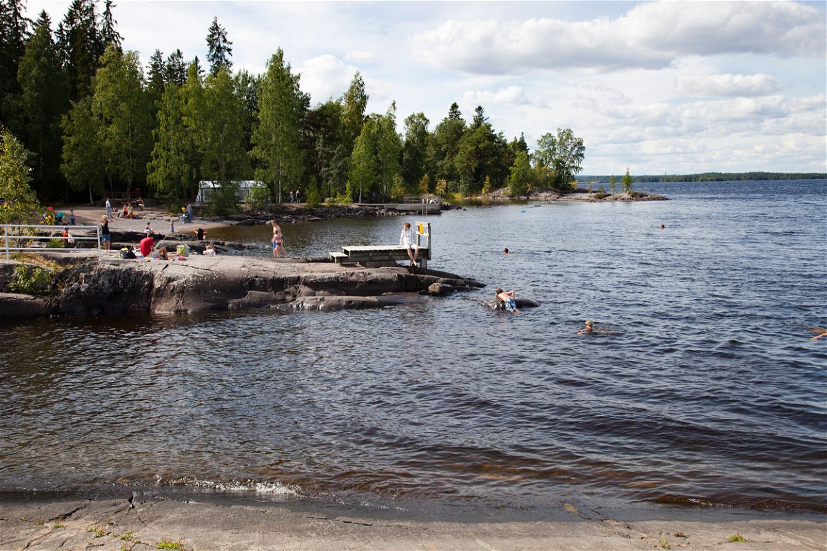 <i>Giulio Andreini/UCG/Getty Images</i><br/>People enjoy nature at a lake in Finland.