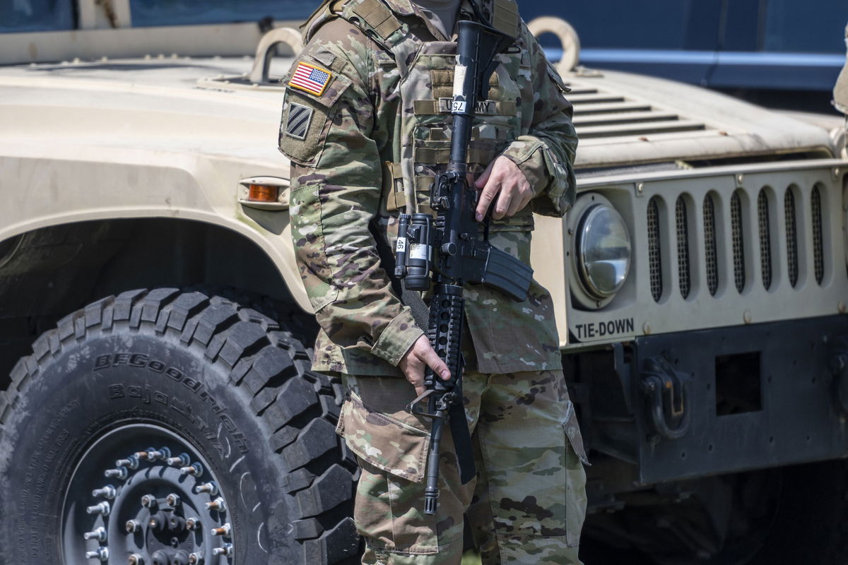 <i>Sergio Flores/Bloomberg/Getty Images</i><br/>A member of the Texas National Guard attends a news conference in Mission