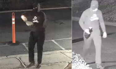 A masked suspect is seen lighting a Molotov cocktail in front of Temple Ner Tamid in a still image from surveillance footage in Bloomfield