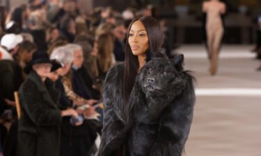 Naomi Campbell wore a glossy black coat complete with the protruding wolf's head.