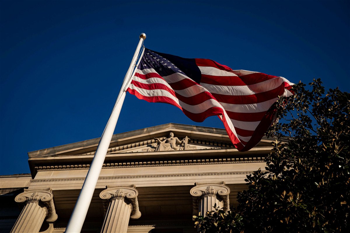 <i>Al Drago/Reuters</i><br/>An American flag is seen outside the Department of Justice building in Washington