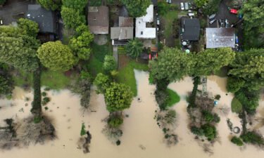 Floodwater from the Russian River approaches homes Sunday following a chain of winter storms