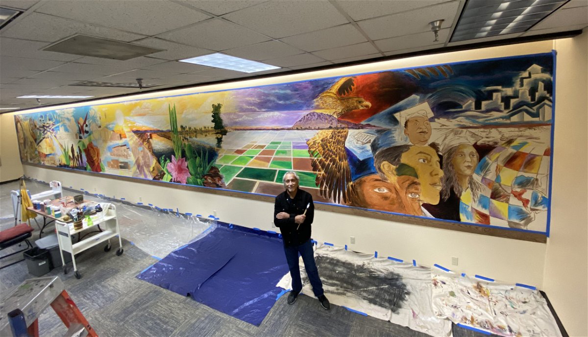IVC alumni artist, Roberto Pozos at work on his mural in the IVC Spencer Library