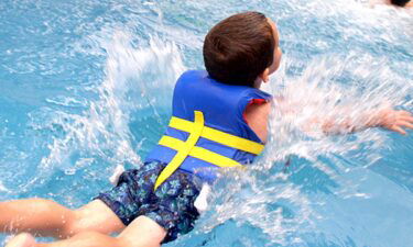 Boy jumps into pool