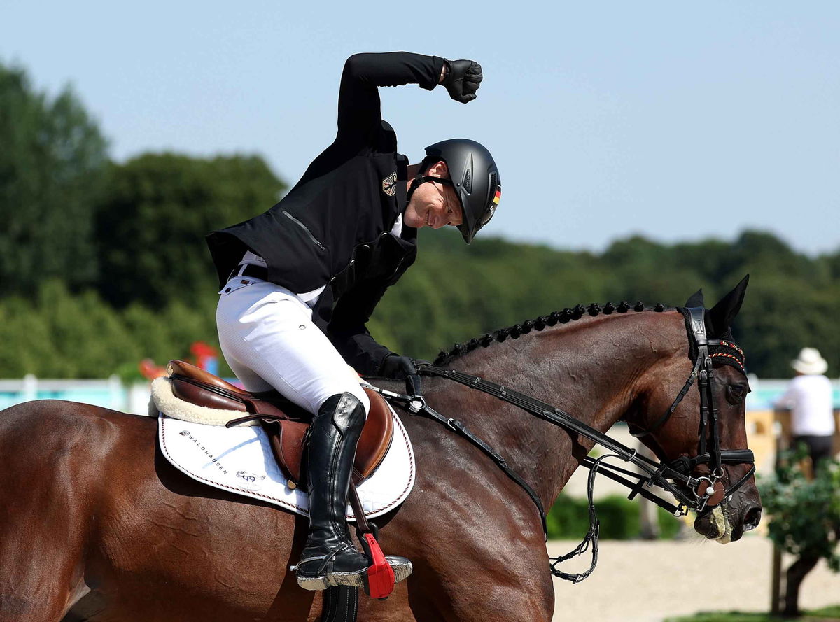 Gold medalists Michael Jung and horse Chipmunk FRH of Team Germany celebrate after their victory in the Eventing Individual Final on day three of the Olympic Games Paris 2024 at Chateau de Versailles on July 29