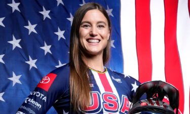 Alise Willoughby poses in front of an American flag