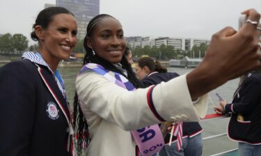 United States' Coco Gauff poses with members of the U.S. team in Paris during the Opening Ceremony