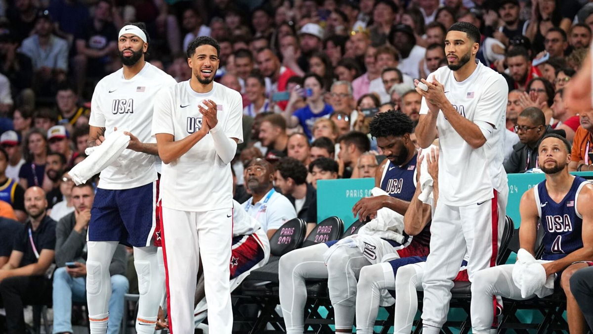 Jayson Tatum celebrates on the bench during a game against Serbia