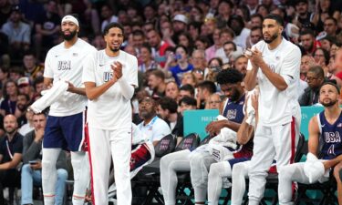 Jayson Tatum celebrates on the bench during a game against Serbia