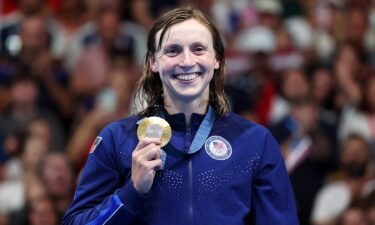 Katie Ledecky poses on the podium with her gold medal