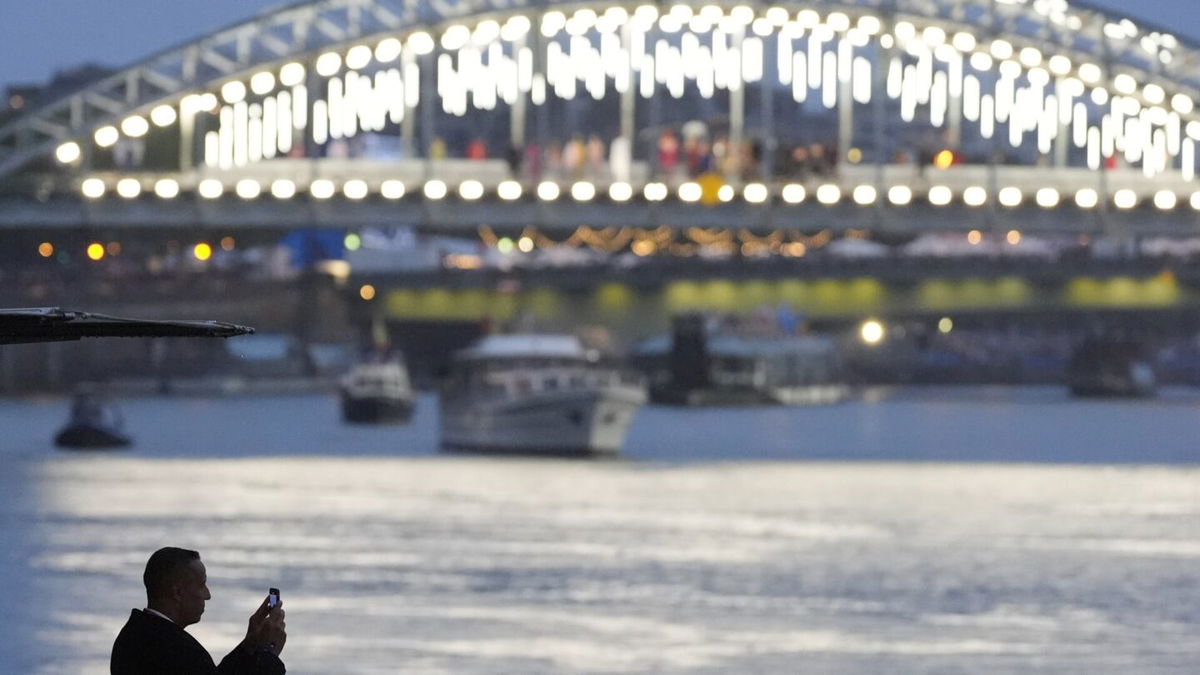 A spectator at the Seine River during the Opening Ceremony