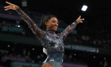 Simone Biles flashes a smile after competing on the vault during women's qualifications on day two of the Paris 2024 Olympic Games.