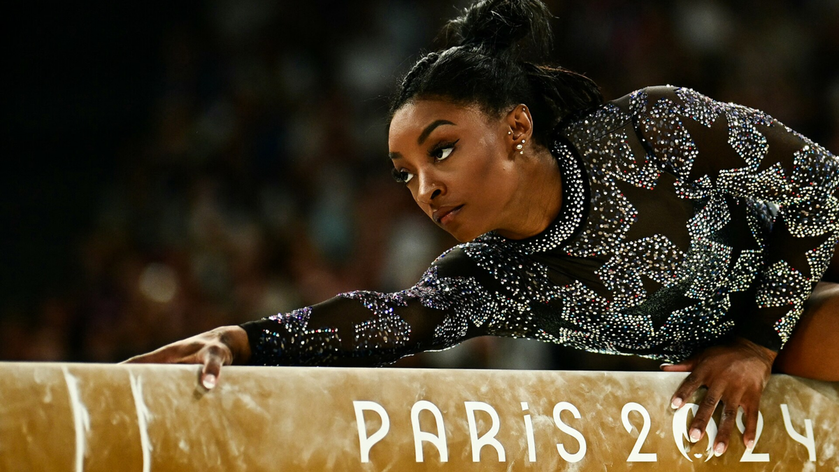 Simone Biles competes on the balance beam during qualifications at the Paris 2024 Olympic Games.