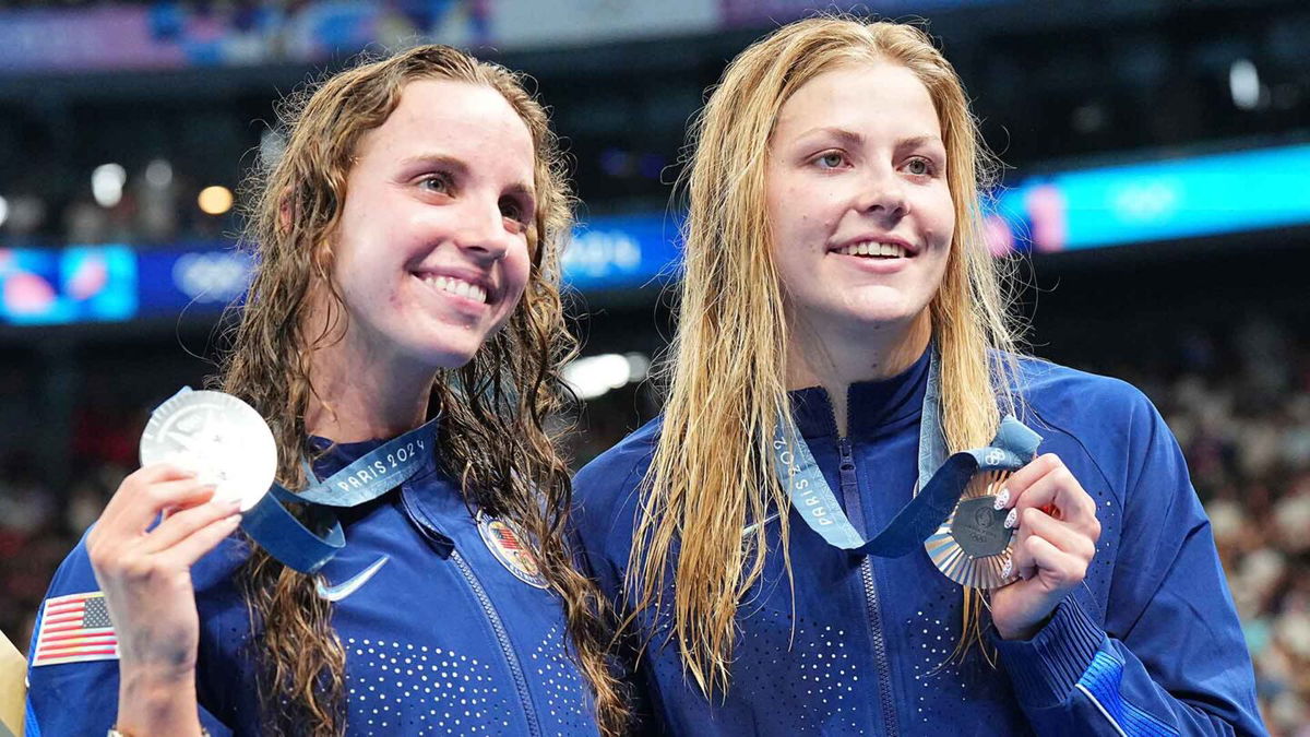 Regan Smith and Katharine Berkoff show off medals won in the women's 100m backstroke.