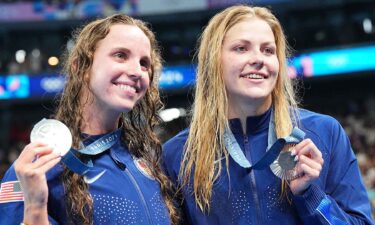 Regan Smith and Katharine Berkoff show off medals won in the women's 100m backstroke.