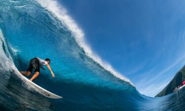 A surfer rides a wave in Teahupo'o