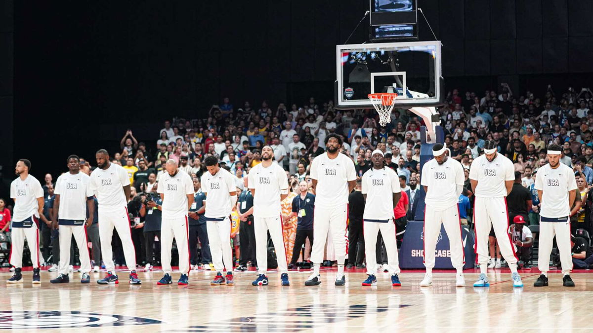 Members of the 2024 U.S. men's basketball Olympic team stand in a line before a game