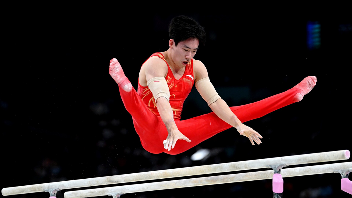 Zhang Boheng of China performs on the parallel bars during the men's individual qualification on day one of the Paris 2024 Olympic Games.