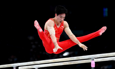 Zhang Boheng of China performs on the parallel bars during the men's individual qualification on day one of the Paris 2024 Olympic Games.