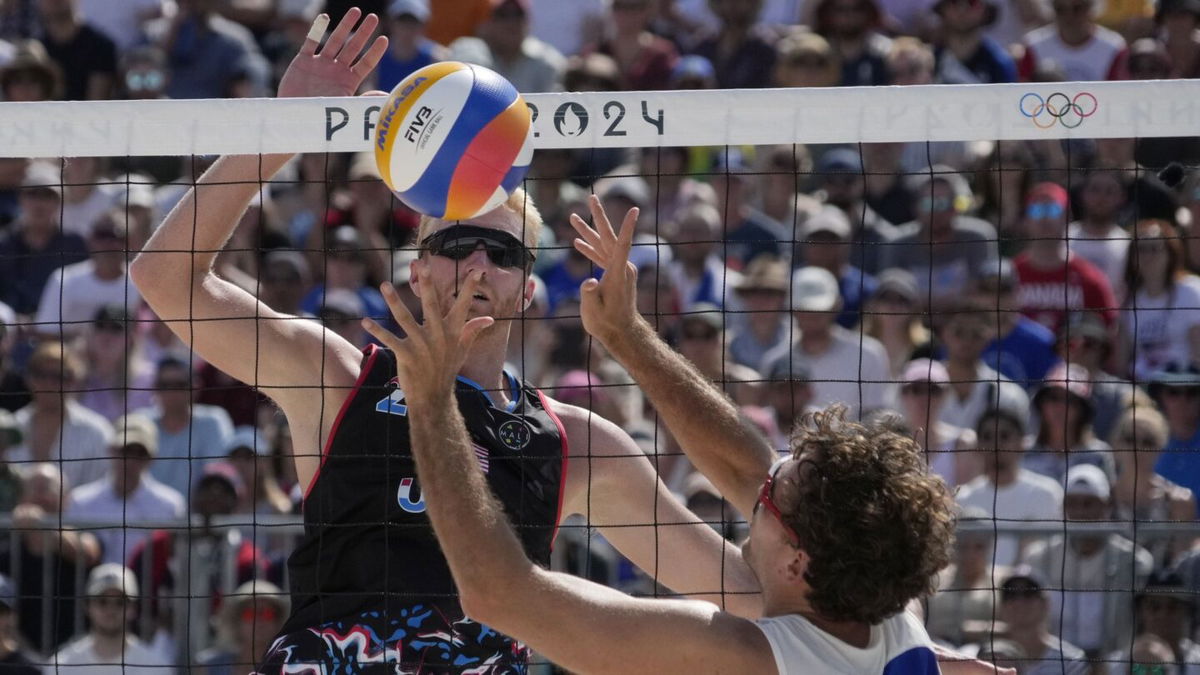 Chase Budinger (USA) and Arnaud Gauthier-Rat (FRA) in action in a beach volleyball preliminary phase match during the 2024 Paris Olympics.