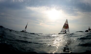 Deizy Nhaquile of Team Mozambique crosses the line at the end of the second Women's Laser Radial Class race on Day Two of the 2020 Tokyo Olympics.