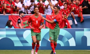 Morocco players celebrate after scoring goal.